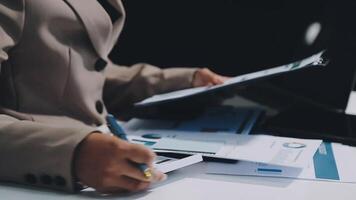 A person in a suit is writing on a piece of paper video