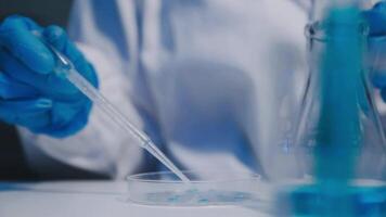 A person in a lab coat is holding a test tube video