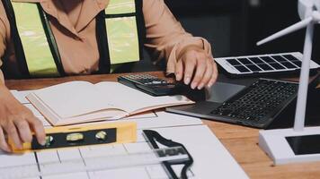A woman working on a laptop and using a calculator video