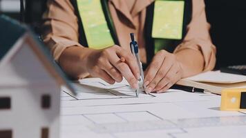 A person is working on a blueprint with a pencil video