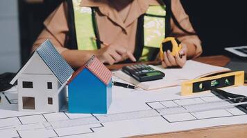A man is working on a blueprint for a house video