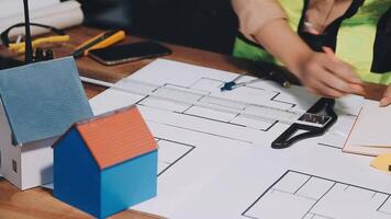 A person is working on a blueprint for a house video