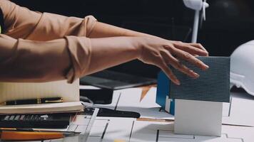 A person is holding a model of a house on a desk video