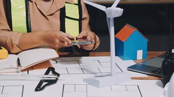 A woman is using her cell phone while working on a project video