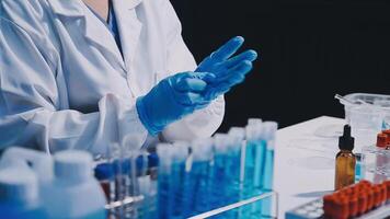 A person in a lab coat and gloves is holding something video