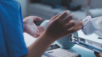 A doctor is holding a tablet while another person is holding a pen video