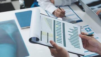 A person is holding a piece of paper with graphs on it video
