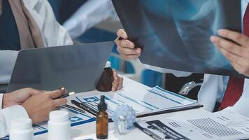 A group of doctors and patients are sitting around a table video