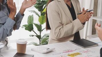 Three business people clapping at a table video