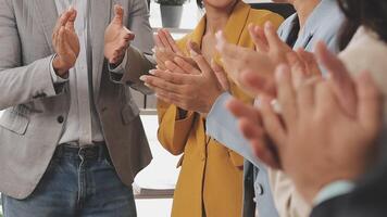 A group of people clapping in a meeting video