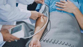A doctor is checking the blood pressure of a patient video