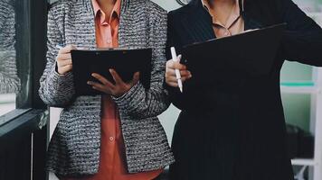 Two business women standing in front of a window video