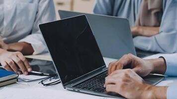 Business people working on laptops at a desk video