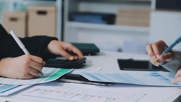 Two people working on paperwork at a desk video