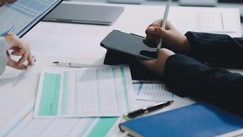 Business people working on paperwork at a desk video