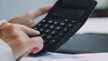A person is using a calculator to calculate the numbers video