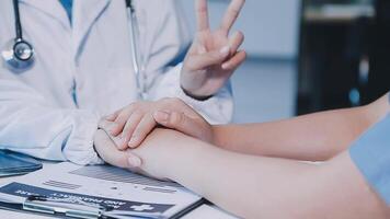 A doctor holding the hand of a patient video