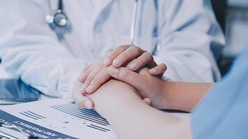 A doctor holding hands with another person video