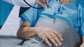 A doctor is checking the heart of a patient video