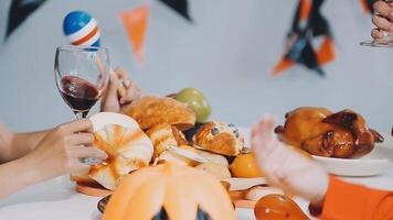 A group of people are toasting with wine at a halloween party video
