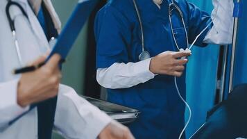 A doctor is holding a stethoscope while another doctor is holding a clipboard video