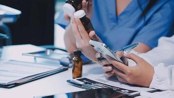 A doctor is using a cell phone while sitting at a desk video