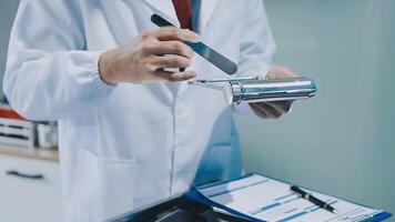 A man in a lab coat is holding a pair of scissors video