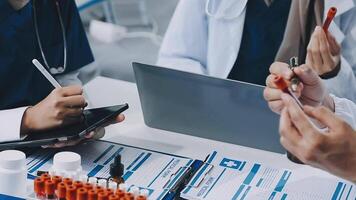 A group of doctors working on a laptop video