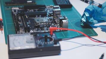 A person is working on a computer motherboard video