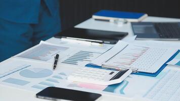 Businessman's desk with financial documents and calculator video