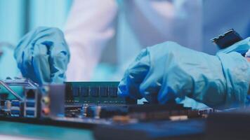 A person in blue gloves is working on a computer video