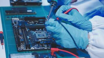 A person in a lab coat is working on a computer video