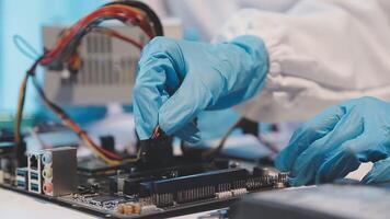A person in blue gloves is working on a computer video