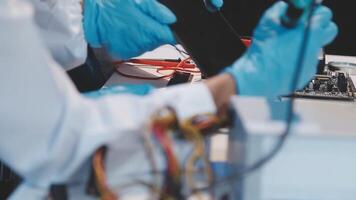A person in blue gloves working on a computer video