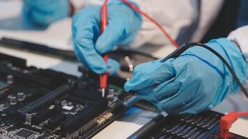 A person in blue gloves is working on a computer video