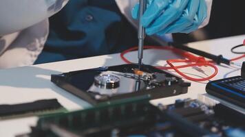 A person in blue gloves is working on a computer video