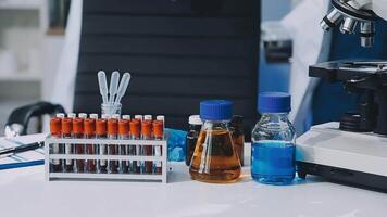 A microscope, a bottle of blood, and a bottle of blood video