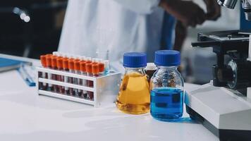 A person in a lab coat is looking at a microscope video