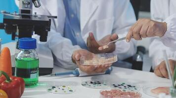 Two people in lab coats are working on food video