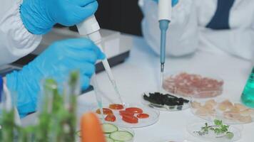 Two people in lab coats are working on food video