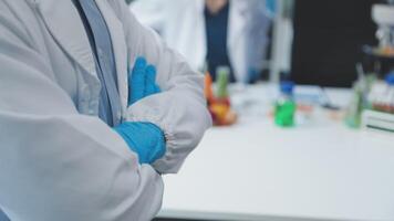 A man in a lab coat and blue gloves video