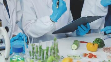 Scientists in lab coats and gloves working with food video