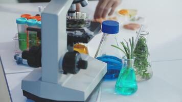 A microscope is on a table with some chemicals video