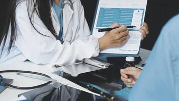 A doctor is writing on a clipboard video