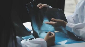 A doctor is holding a piece of paper with an x - ray on it video
