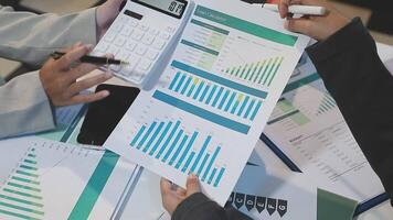 Business people working on a document with graphs and papers video