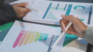 Business people working on a document with graphs video