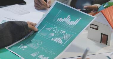 Business people working on a project with graphs and diagrams video
