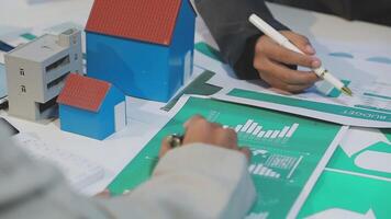A person is working on a paper with a house on it video