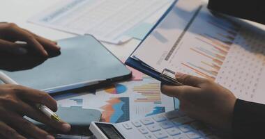 Business people working on financial documents video